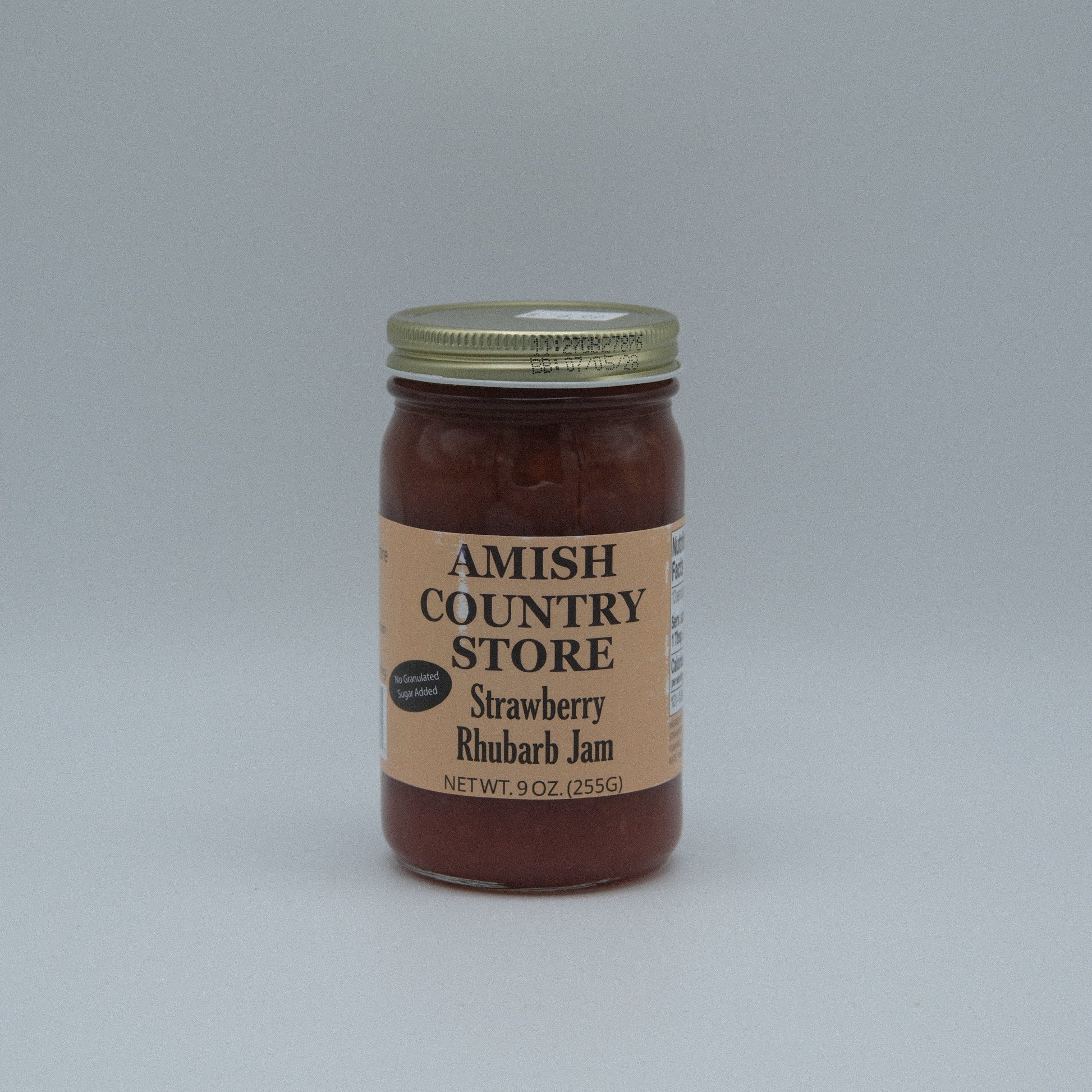 Canned Strawberry Rhubarb Jam in 8 oz jar from Amish Country Store, no sugar added, with fresh strawberries and rhubarb visible.