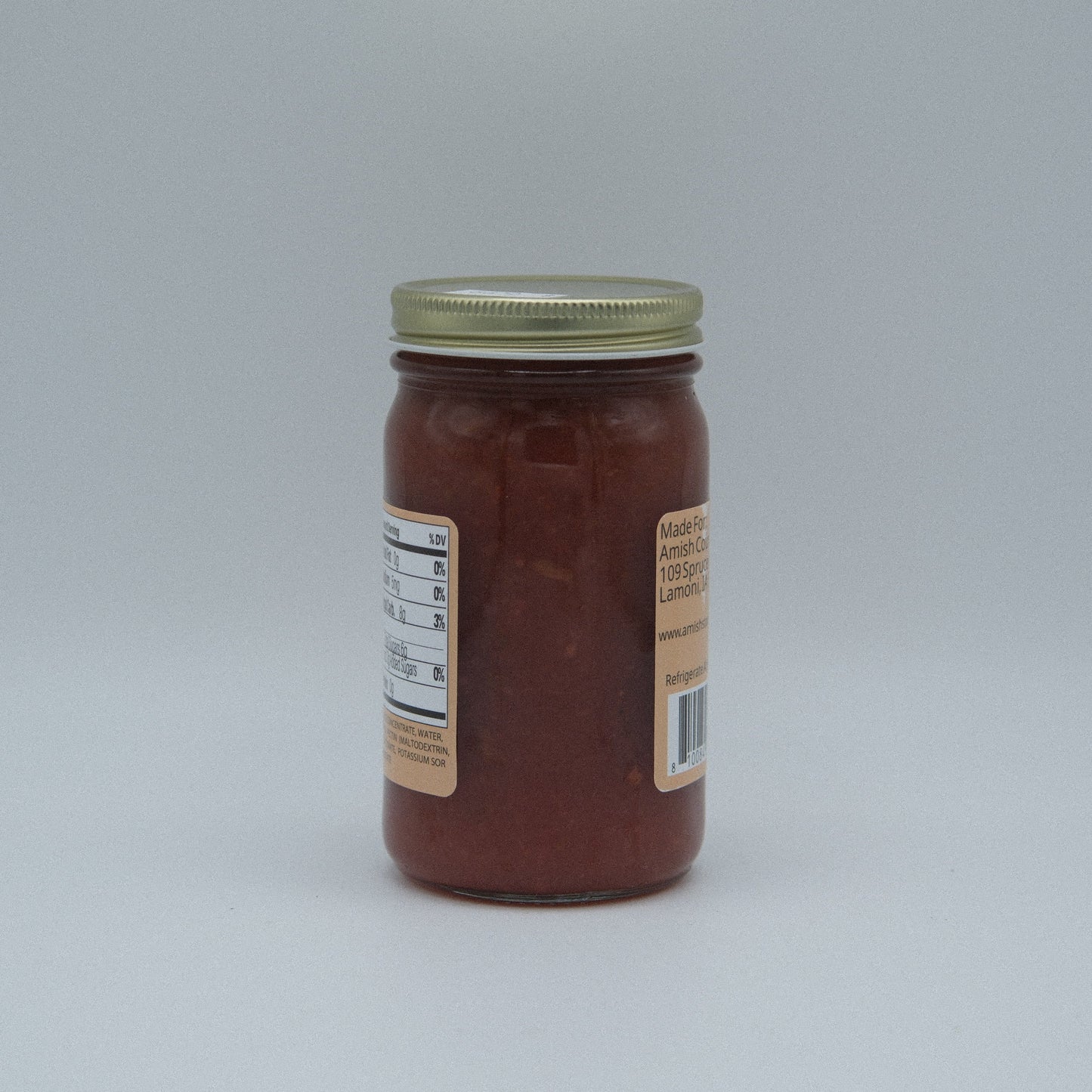 Canned strawberry rhubarb jam by Amish Country Store in an 8 oz jar, no sugar added, with fresh fruit visible inside.