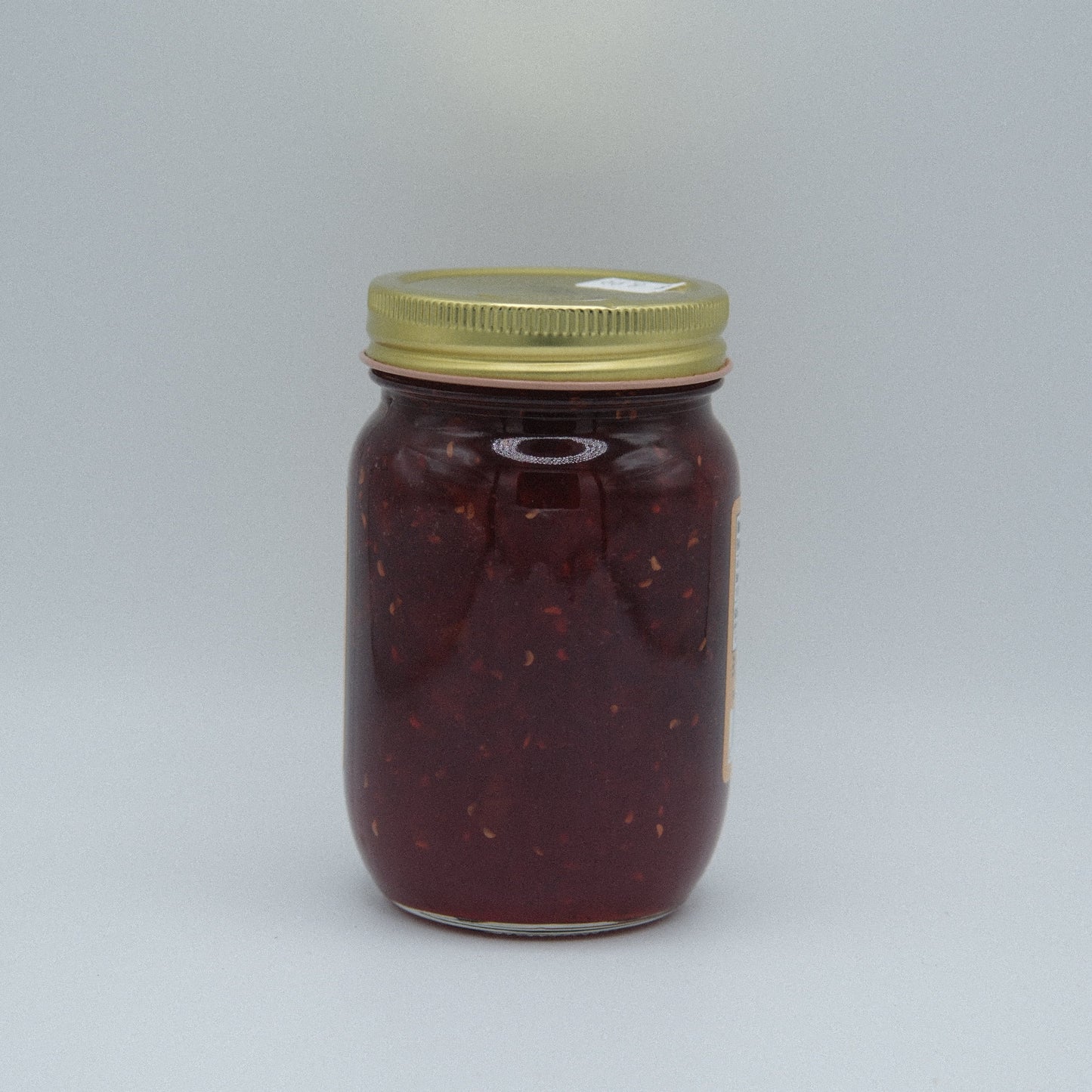 Canned Amish Country Store Traffic Jam in 18oz jar, showing the label and jam inside the glass jar for natural fruit spread.
