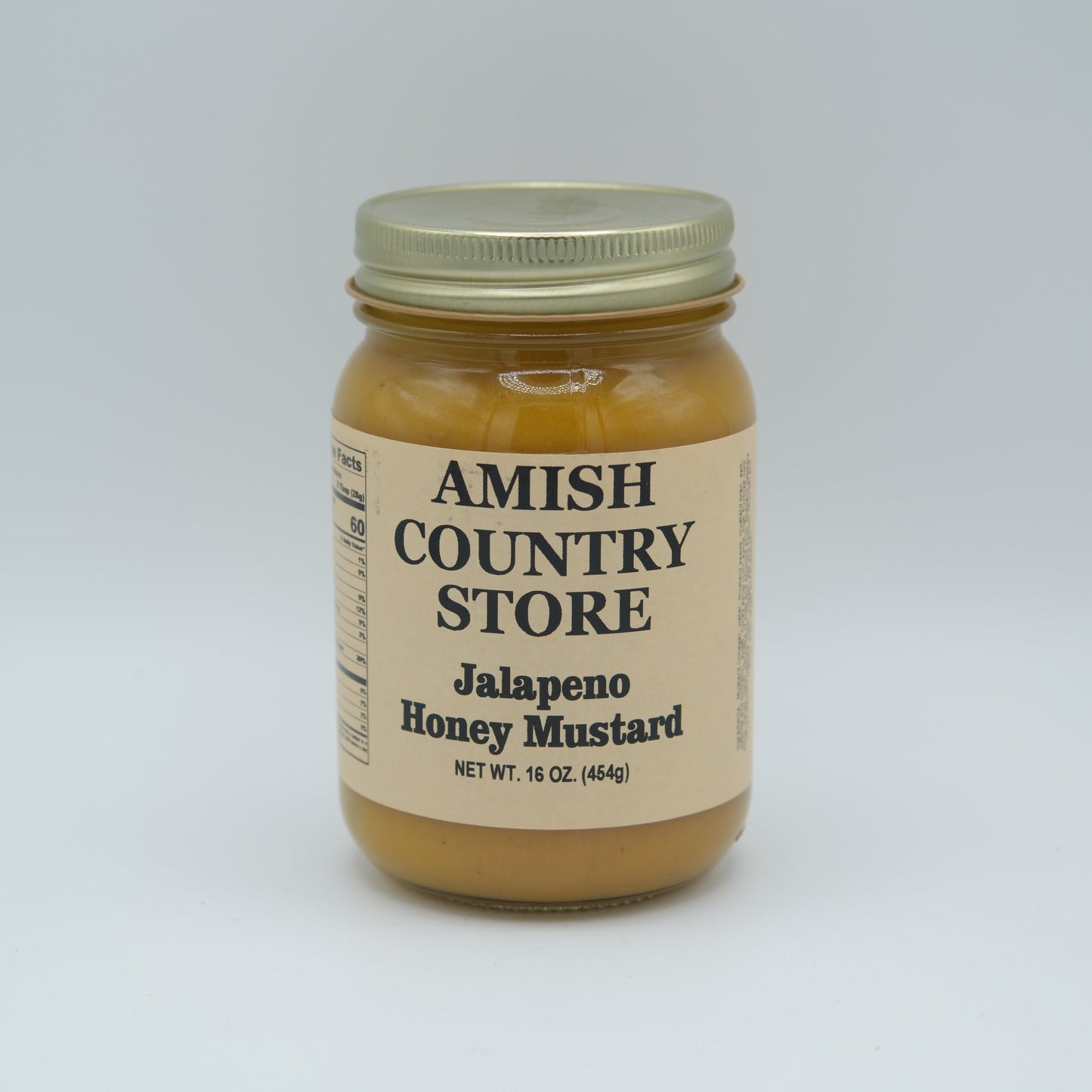 Canned Jalapeno Honey Mustard from Amish Country Store in a glass jar, showcasing the spicy mustard with jalapeno peppers.