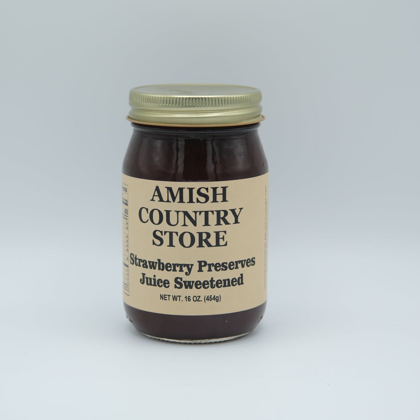 Canned Amish Country Store strawberry preserve juice in a 16oz jar, showcasing fresh strawberry preserves in glass jar.
