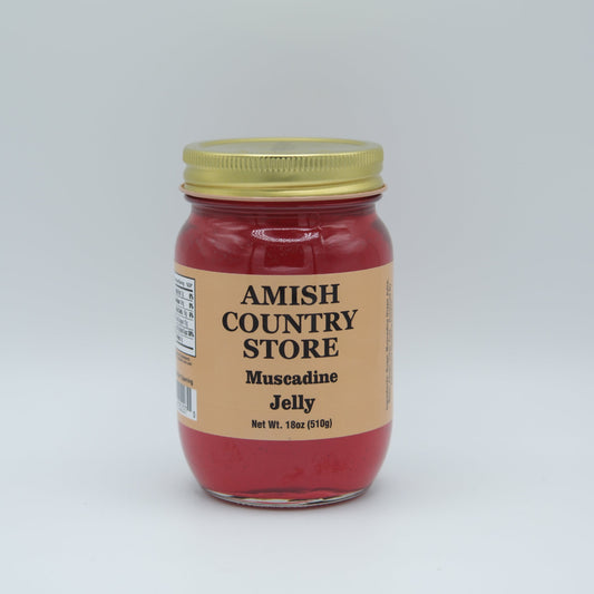Canned Muscadine Jelly 18oz jar from Amish Country Store, smooth purple jelly with a gold lid sitting on a wooden surface.