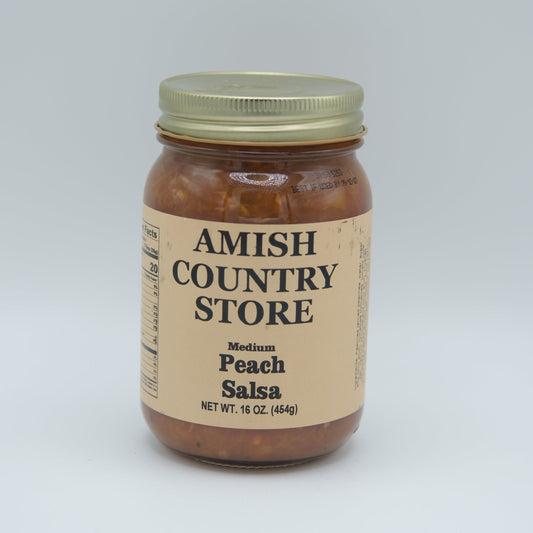 Canned peach salsa in a 16 oz jar from Amish Country Store, showing the label and peaches visible through the glass.