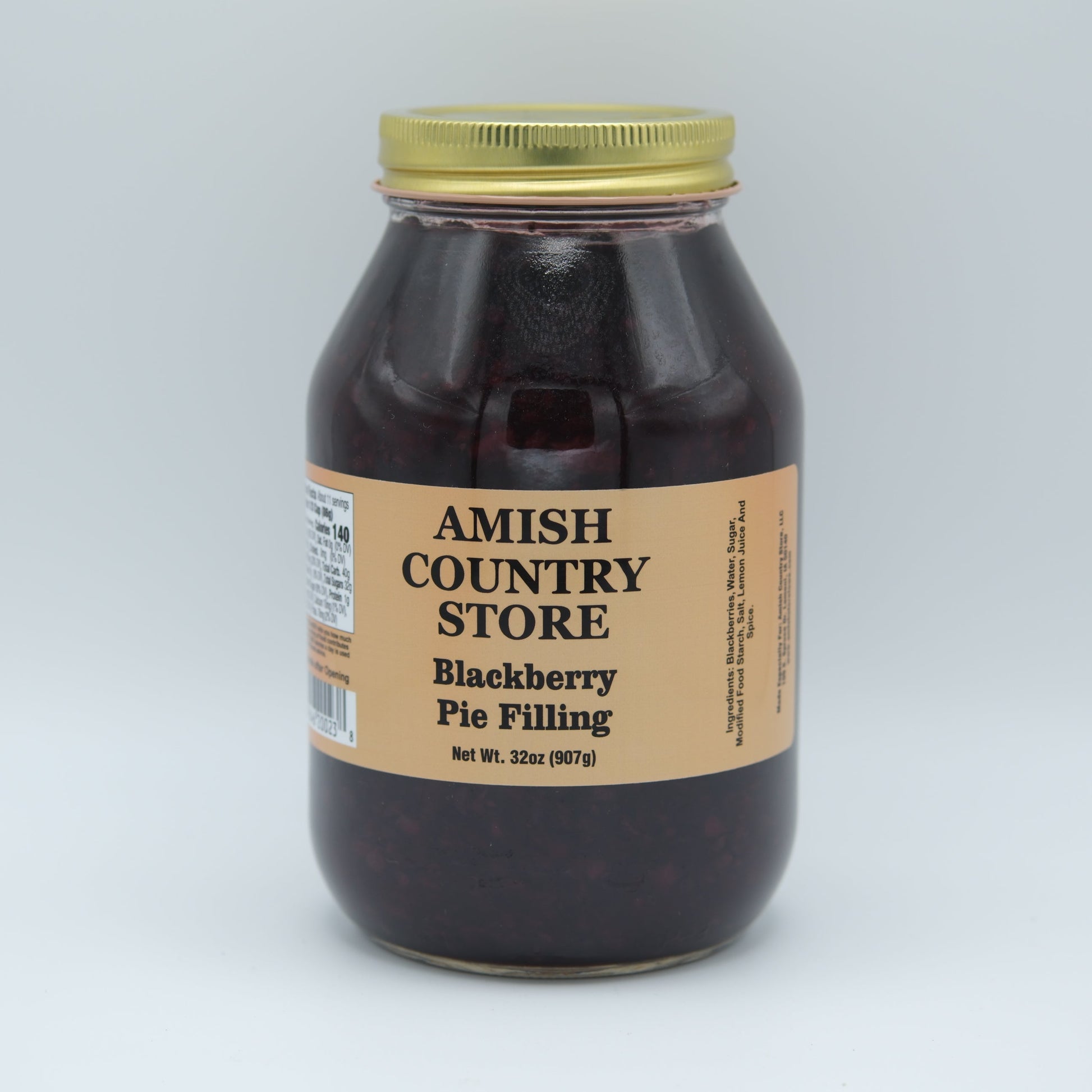 Amish Country Store Blackberry Pie Filling jar with label, showing rich dark blackberries and fruit filling inside.