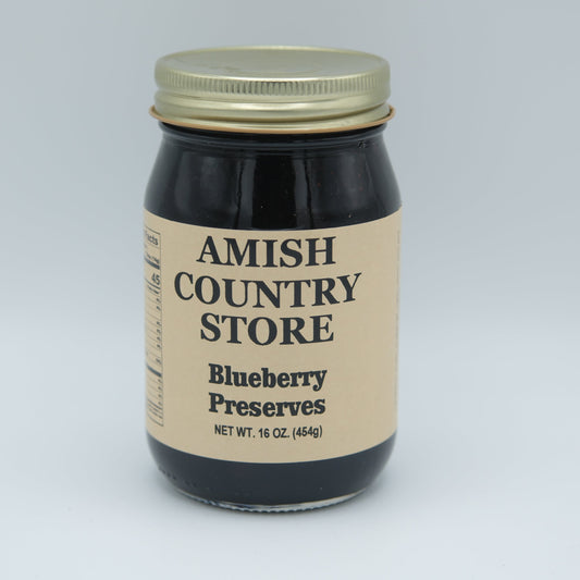 Canned Amish Country Store blueberry preserves in a 16 oz jar, showing fresh blueberries and label on the jar.