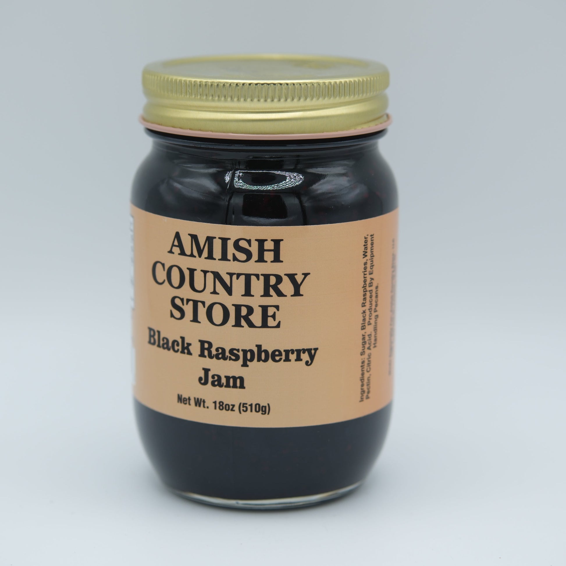 Amish Country Store black raspberry jam in 18 oz canned jar, smooth texture with fresh black raspberry fruit visible.