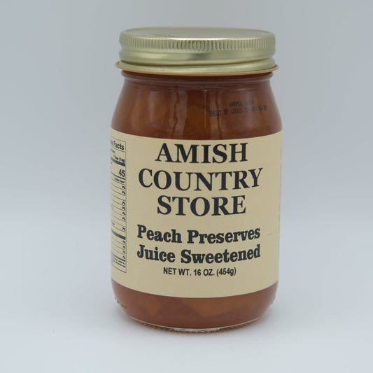 Canned peach preserve juice in a 16 oz jar with Amish Country Store label, showcasing the preserved peach liquid inside.