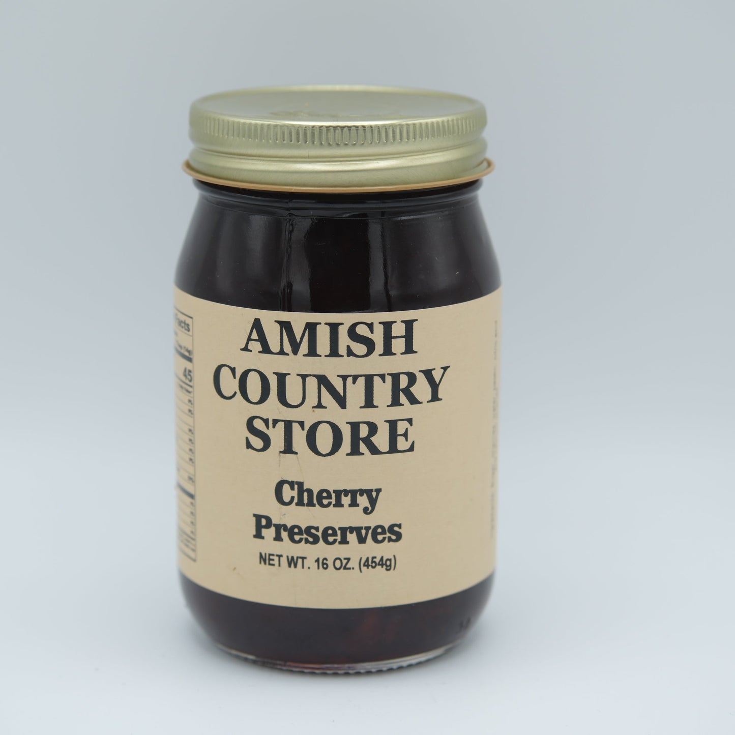 Canned cherry preserves in a 16 oz jar from Amish Country Store, showing glossy red cherries and label.