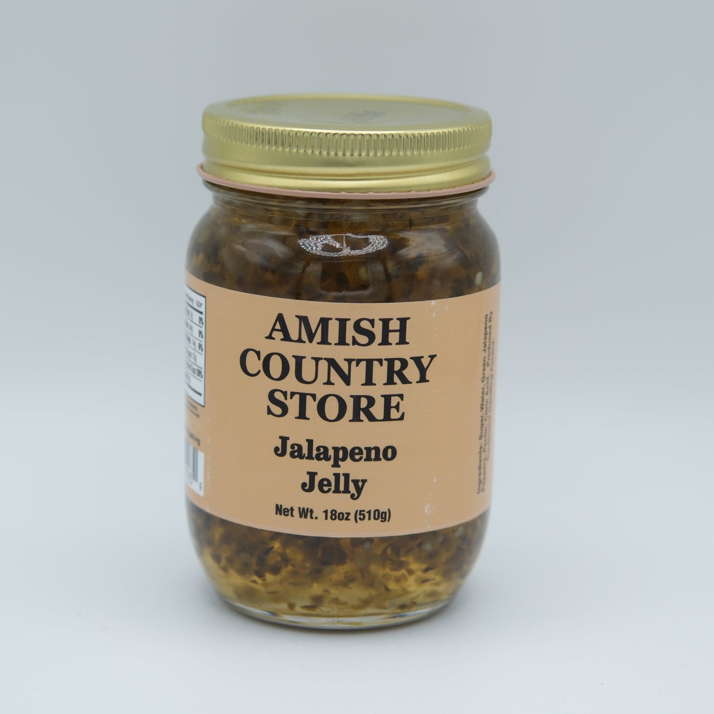 Amish Country Store jalapeno jelly in 18oz canned jar, bright green jalapenos in clear glass jar, ready for spreading or tasting.