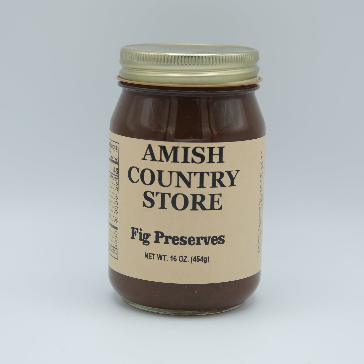 Canned Amish Country Store fig preserves jar with label, 16 oz, showcasing glossy figs inside the preserves.