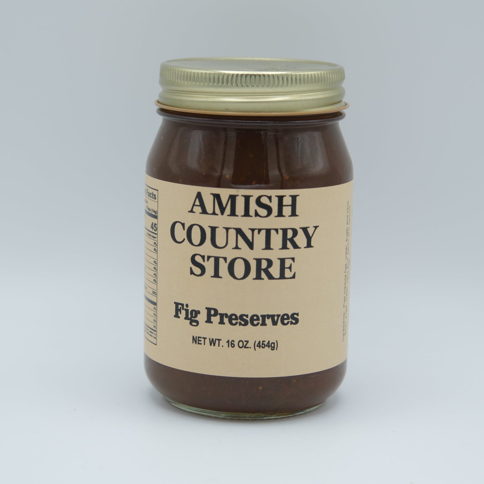 Canned Amish Country Store fig preserves jar with label, 16 oz, showcasing glossy figs inside the preserves.