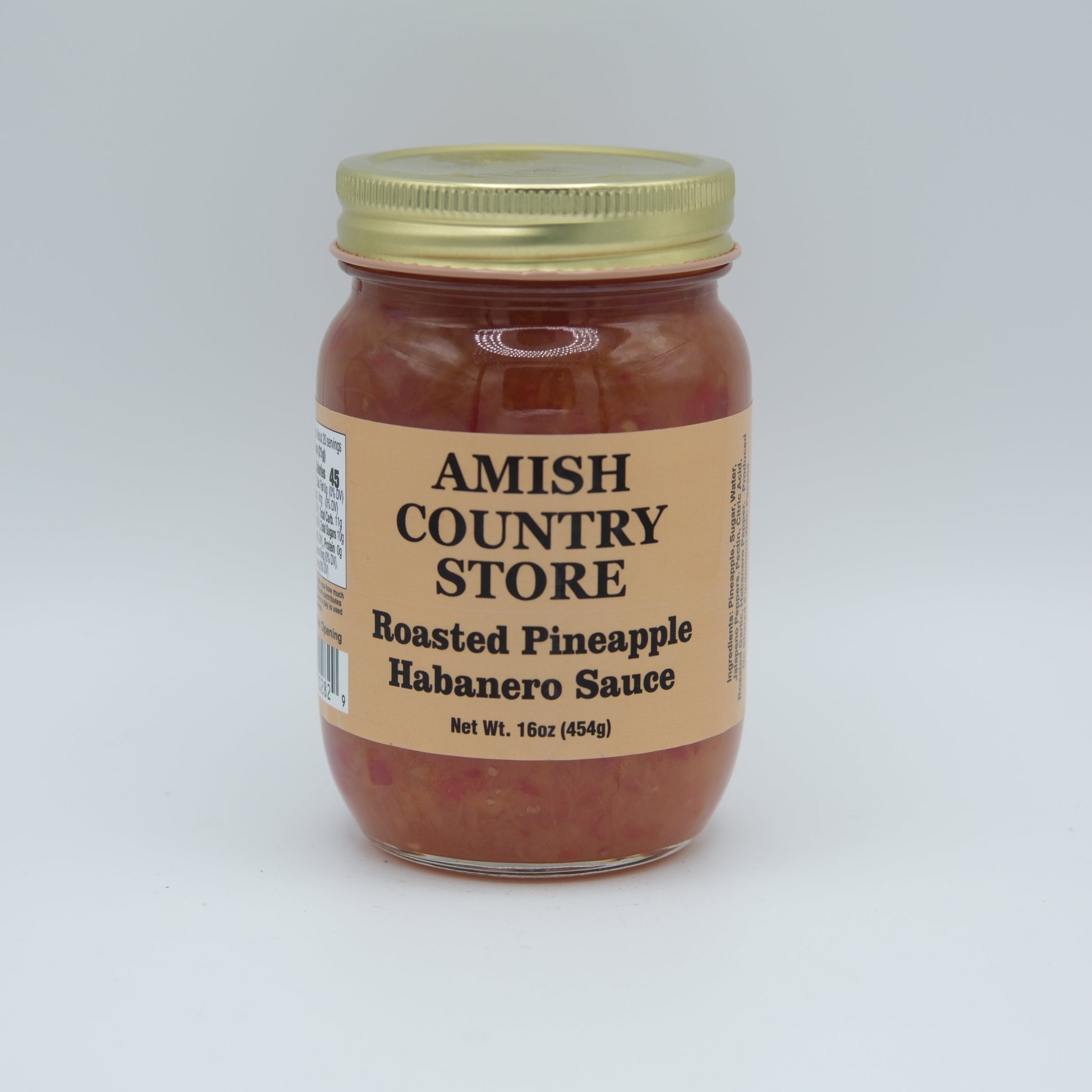 Canned roasted pineapple habanero sauce in a 16oz jar from Amish Country Store, showcasing the vibrant sauce with pineapple and peppers.