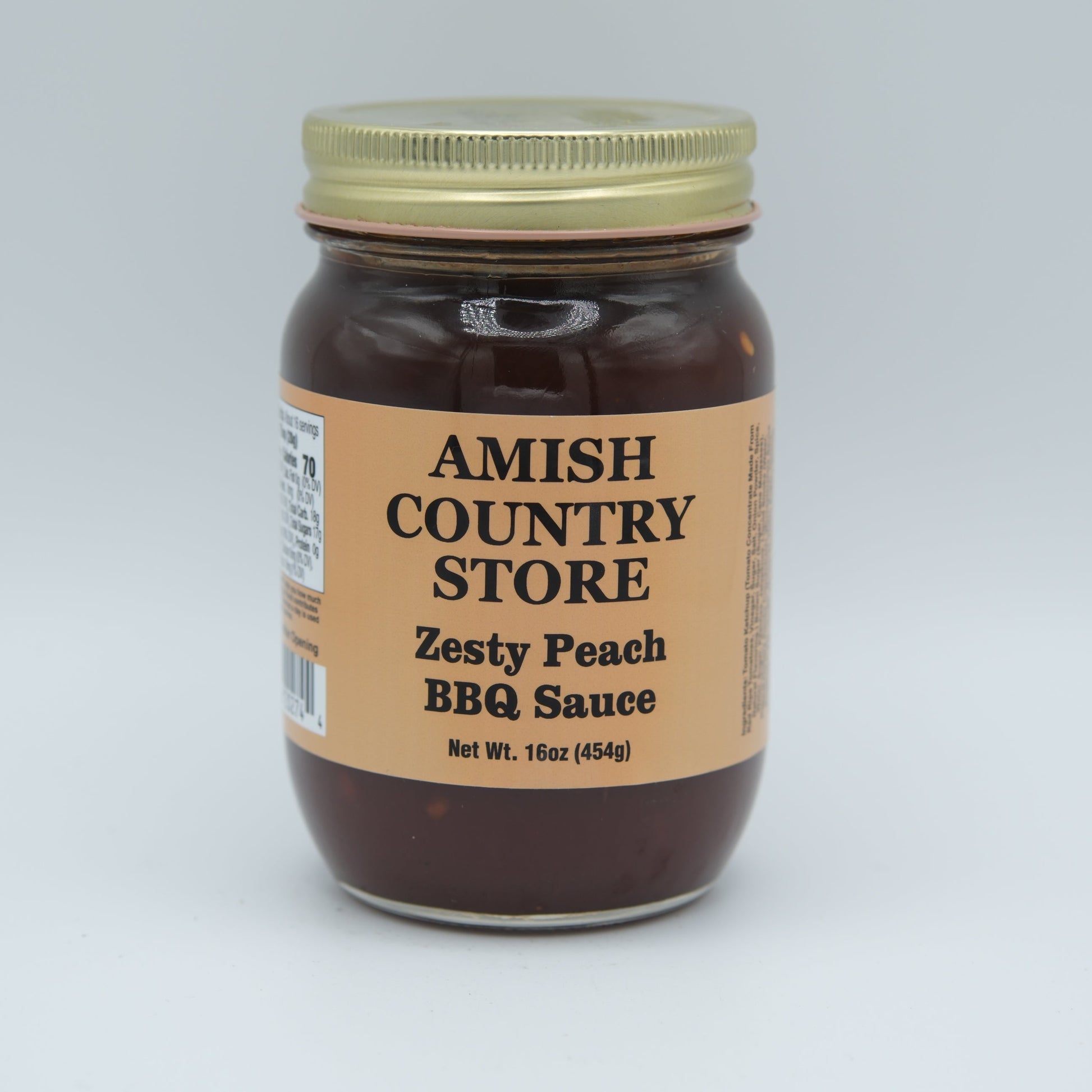 Canned Zesty Peach BBQ Sauce by Amish Country Store in a 16 oz jar, showcasing fresh peaches and rich barbecue flavor.