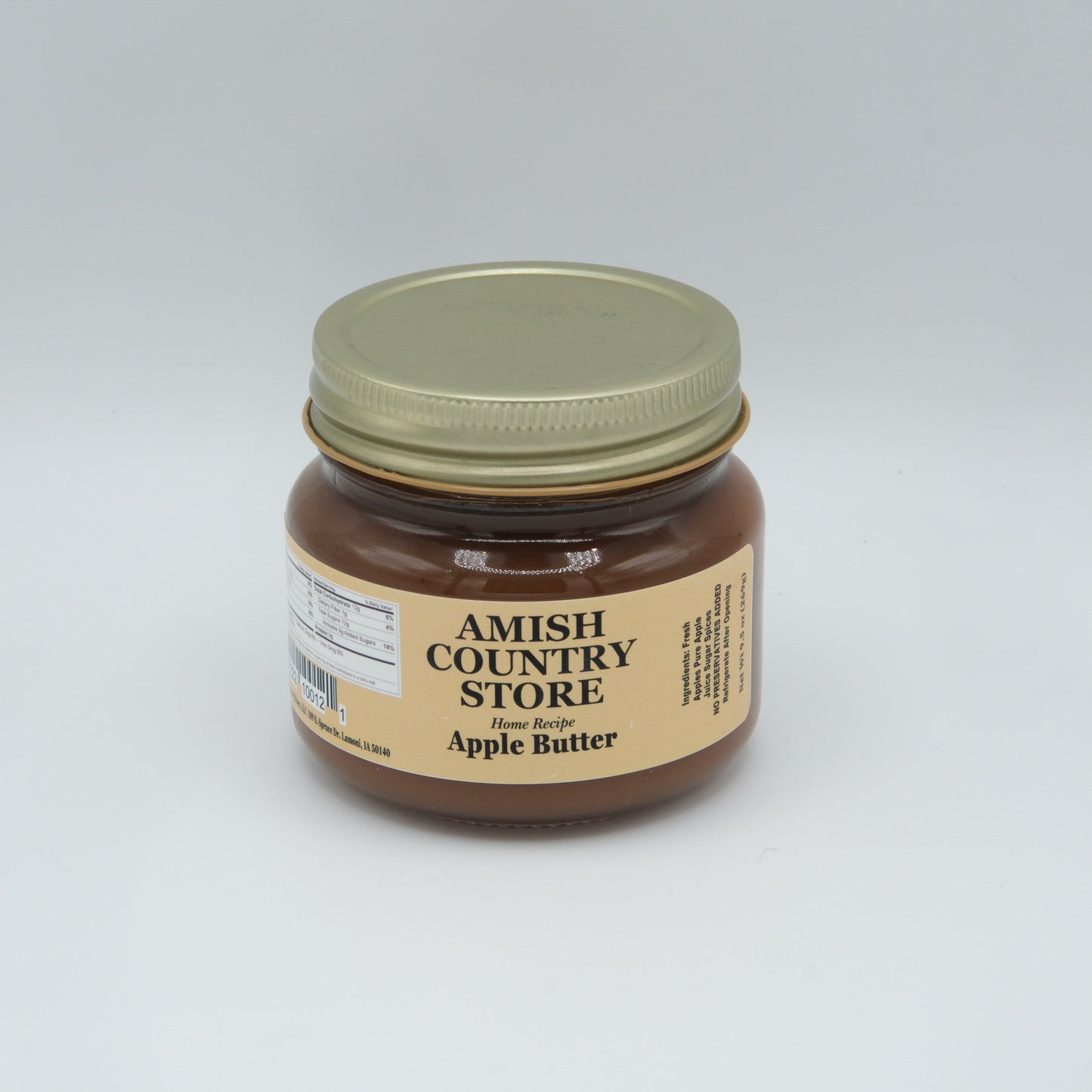 Canned Amish Country Store apple butter jar with label, showcasing smooth, dark apple spread in a glass jar.