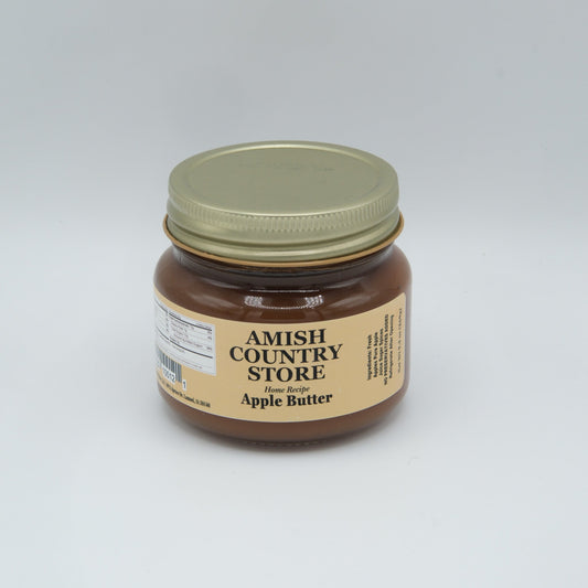 Canned Amish Country Store apple butter jar with label, showcasing smooth, dark apple spread in a glass jar.