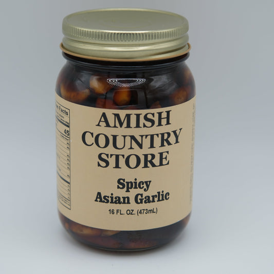Canned Amish Country Store Spicy Asian Garlic 16oz jar showing garlic cloves and spicy sauce inside the can