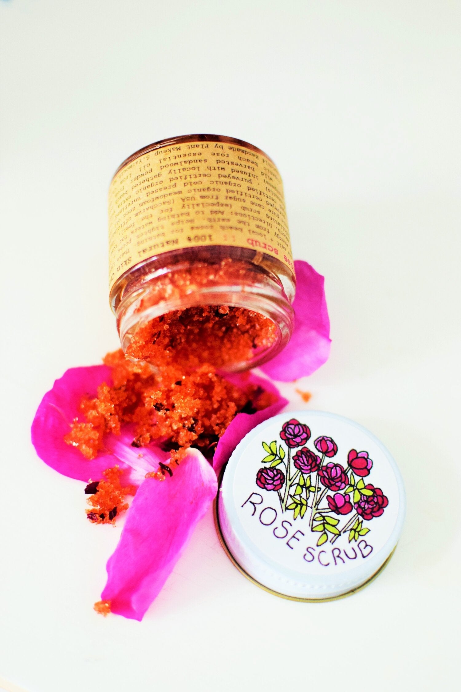 Plant Makeup Beach Rose Scrub in a clear jar with rose petals, showcasing the natural exfoliating product and floral ingredients.