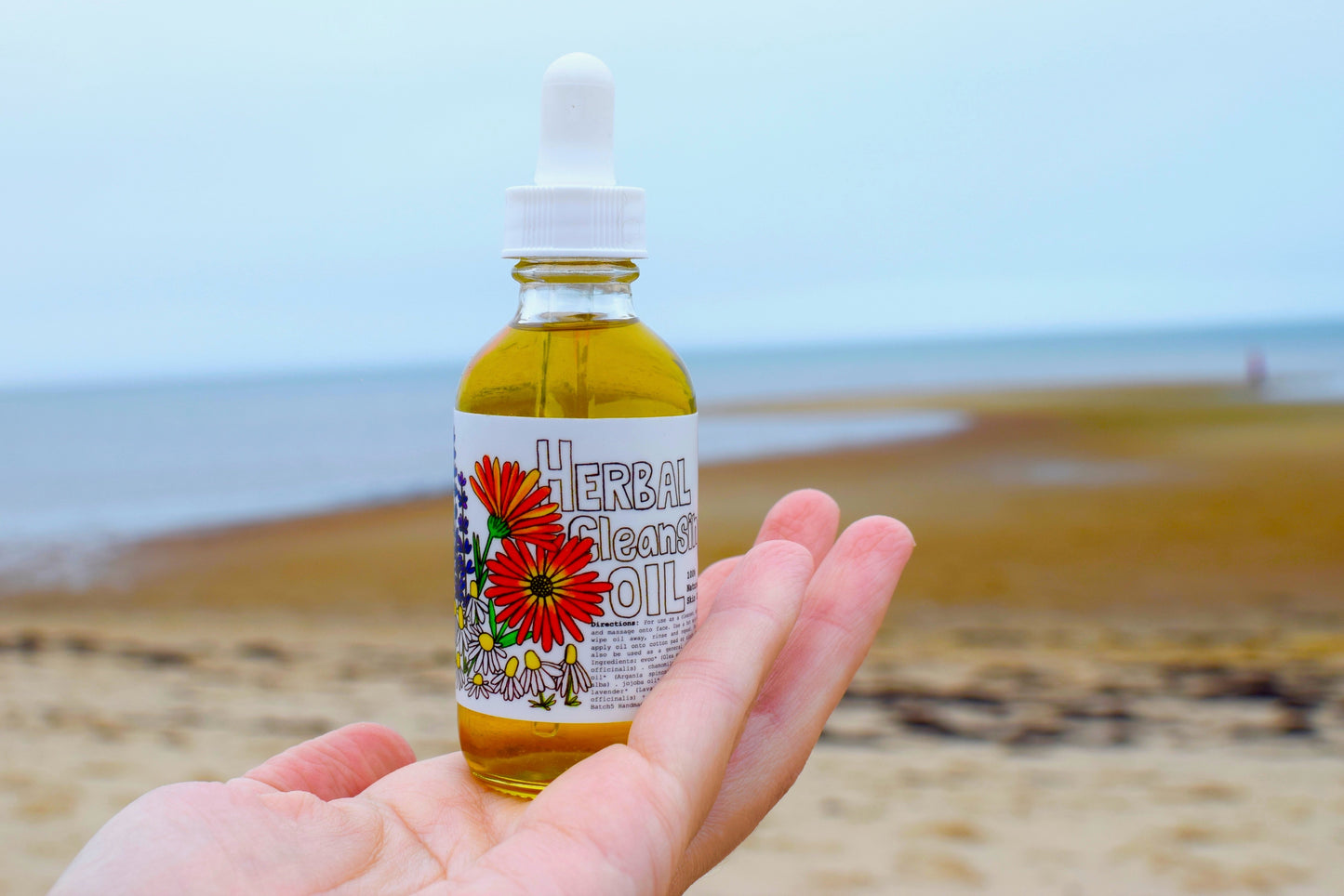 Herbal cleansing oil from Plant Makeup displayed in a clear bottle with natural botanical ingredients visible.