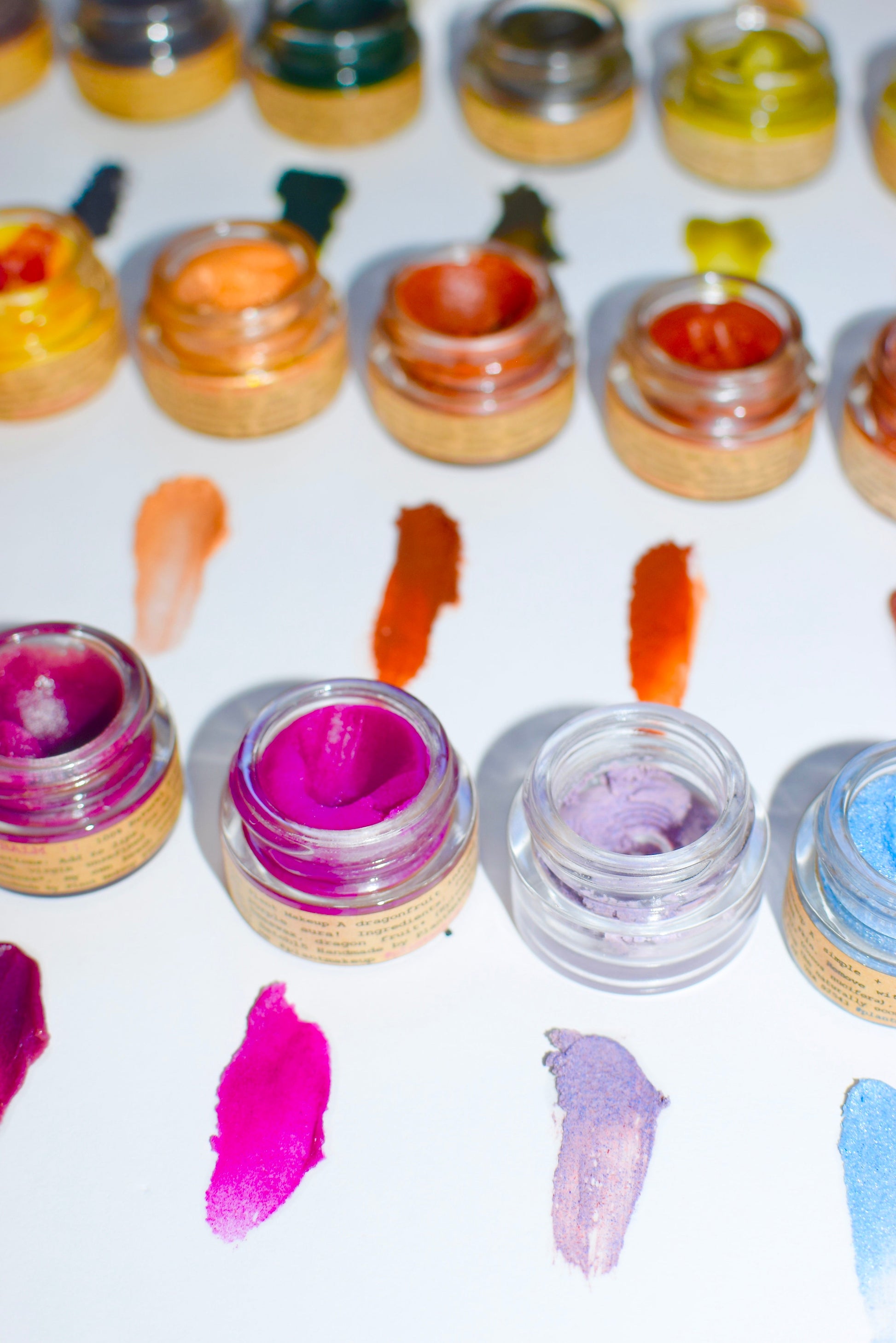 Dragon Fruit lip gloss by Plant Makeup featuring a glossy tube with vibrant pink and purple packaging.