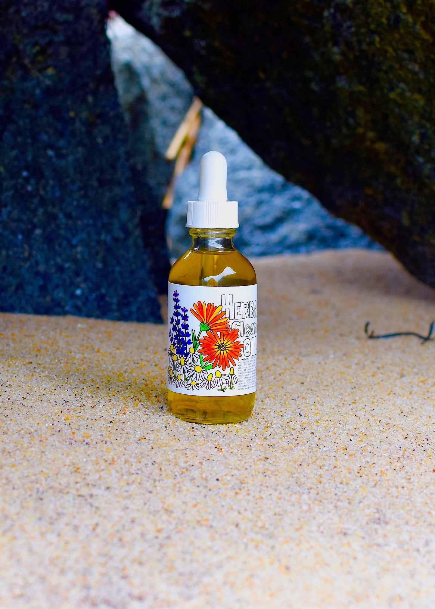Herbal cleansing oil by plant makeup displayed in a clear glass bottle with herbal infusion, ready for skincare use.