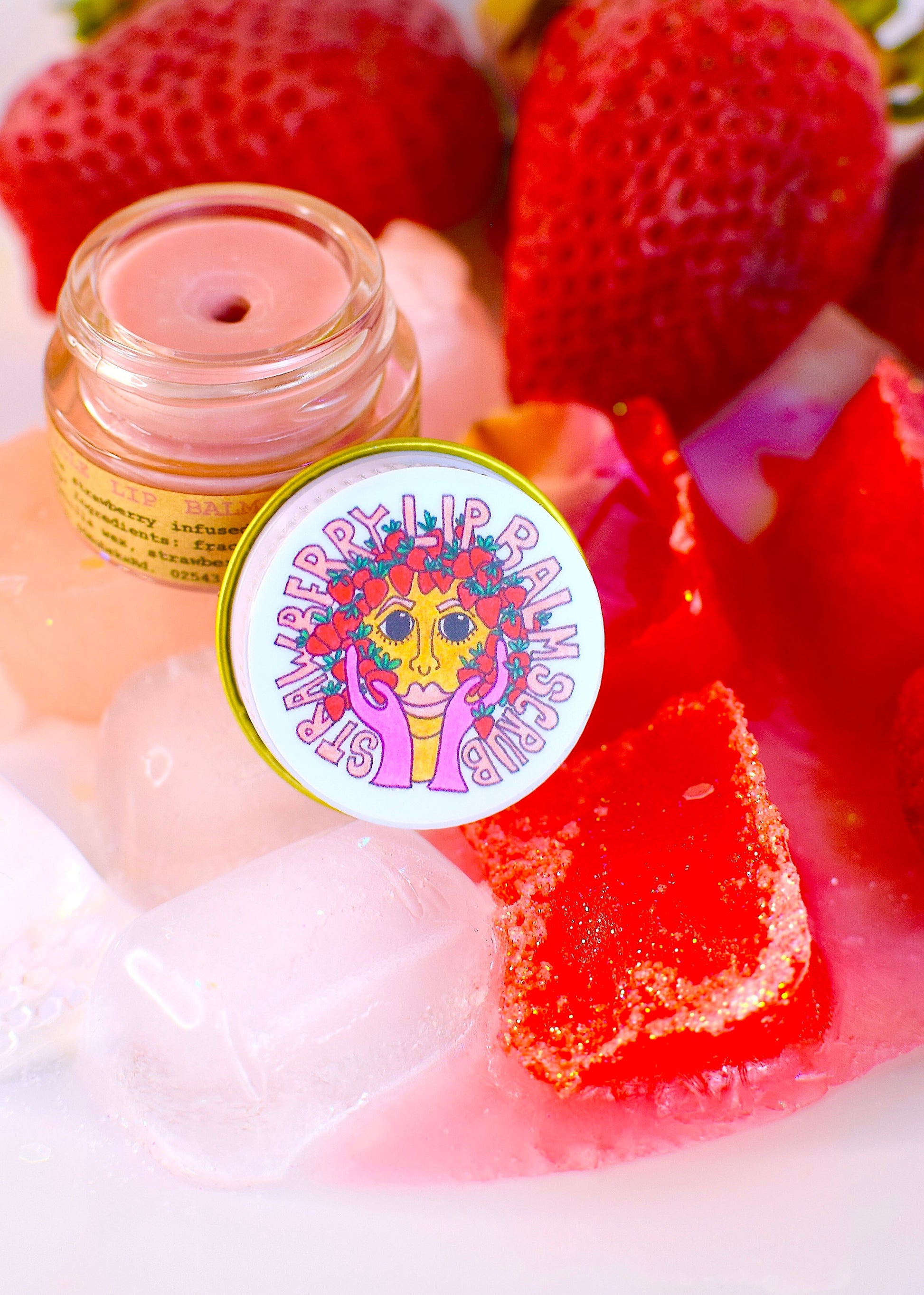 Plant Makeup Strawberry Dreamsicle Lip Balm Scrub in a jar with a creamy, pink-colored scrub visible, showcasing its smooth texture.