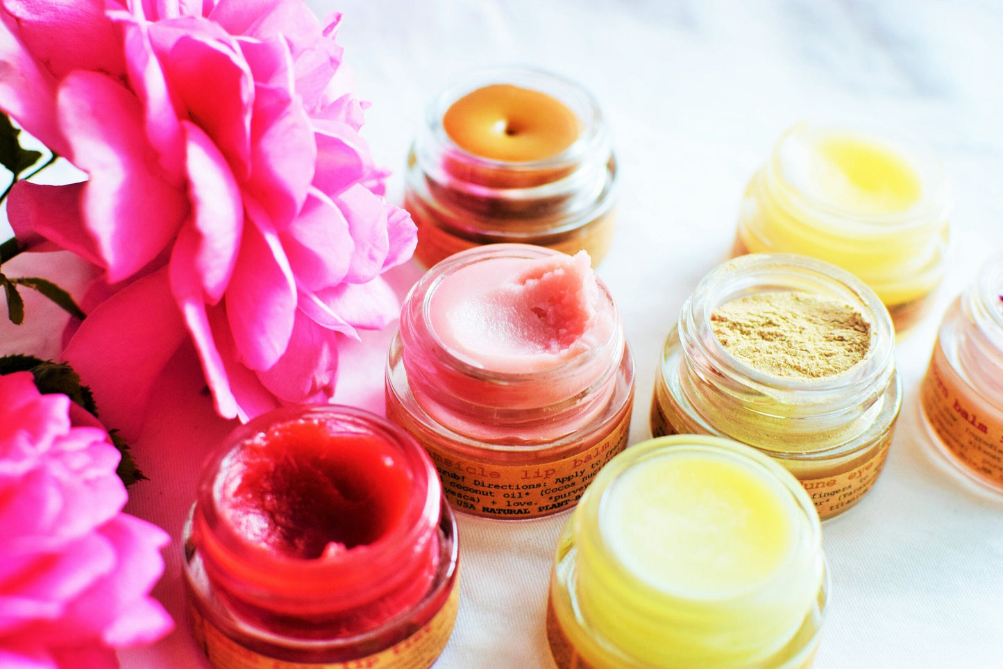 Plant Makeup Strawberry Dreamsicle Lip Balm Scrub in a jar with pink and white swirled texture, featuring fresh strawberries on the label.