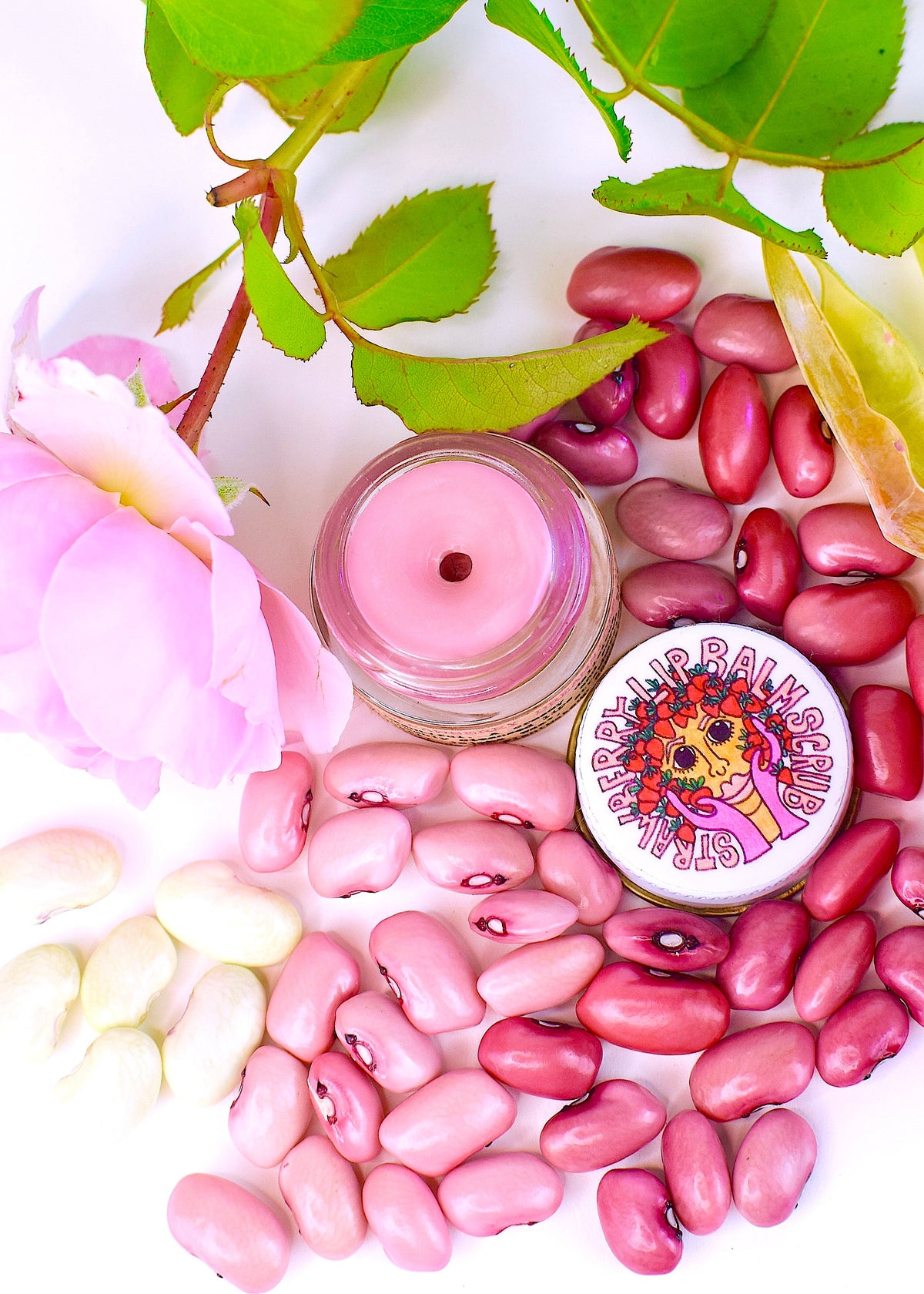 Plant Makeup Strawberry Dreamsicle Lip Balm Scrub in a clear jar with a pink and white creamy texture and fresh strawberry scent.