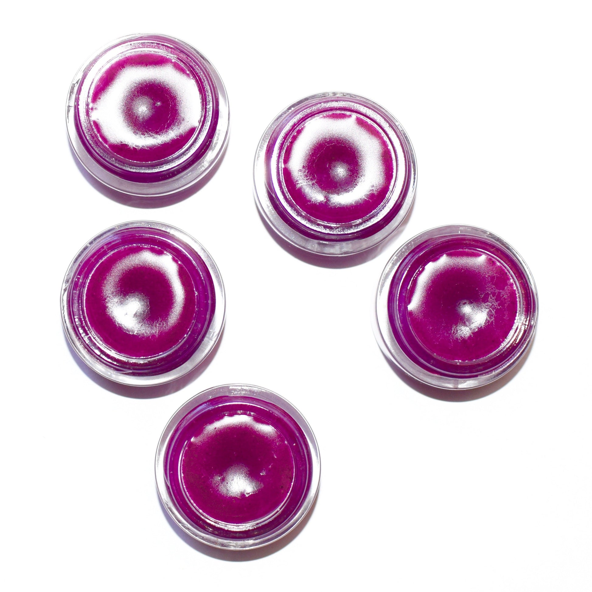 Dragon Fruit lip gloss by plant makeup, featuring a vibrant pink tube with glossy finish, displayed on a neutral background.