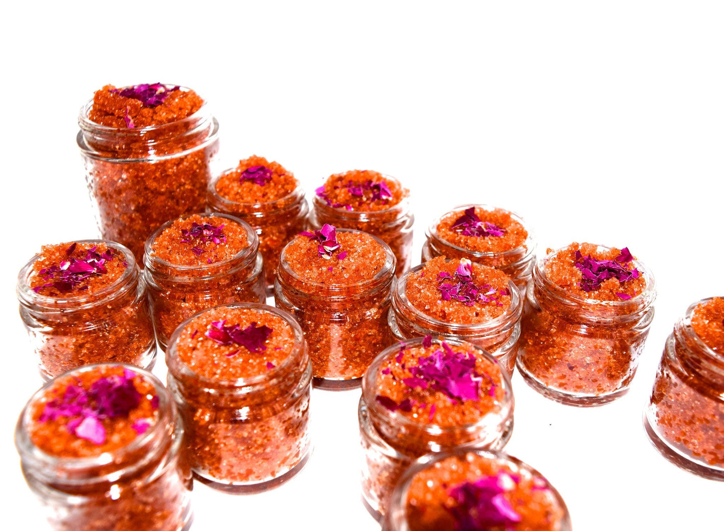 Plant Makeup Beach Rose Scrub jar with pink rose petals and natural exfoliants, showcasing the product's textured, botanical ingredients.