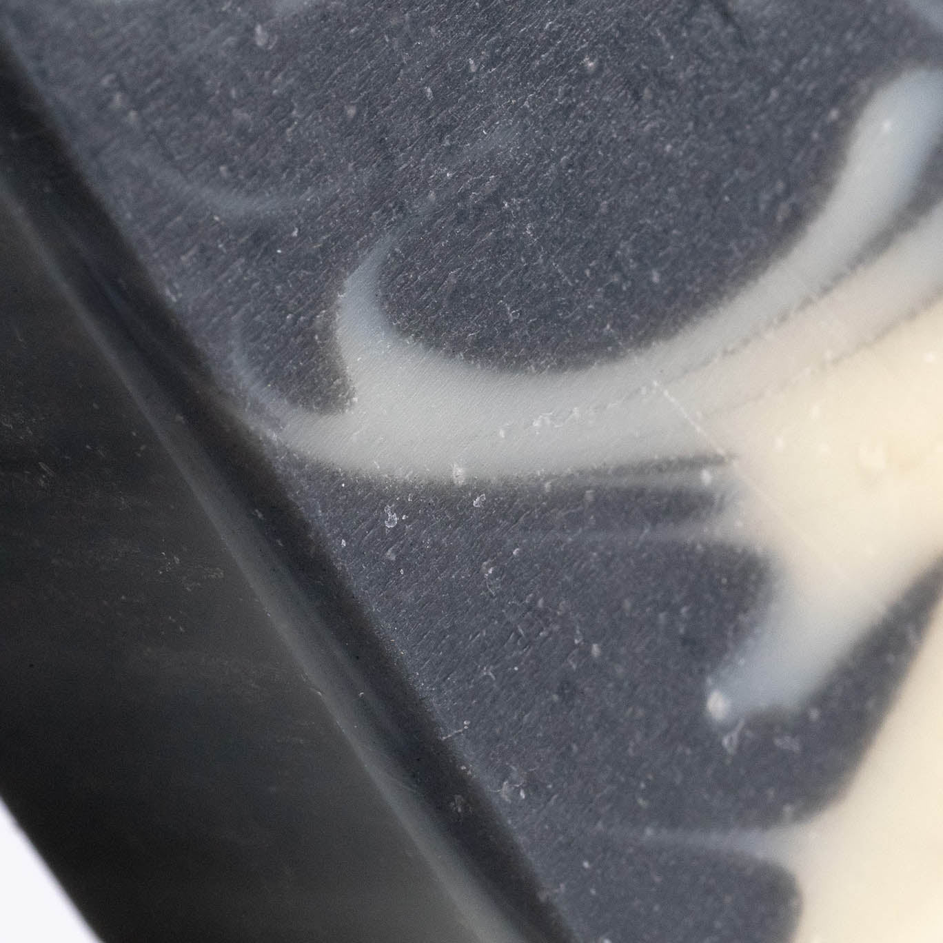 Close-up of Rustic Strength’s Bar Soap | Detoxifying Charcoal, featuring black and white swirls with smooth texture and intricate marbling—perfect for sensitive skin.