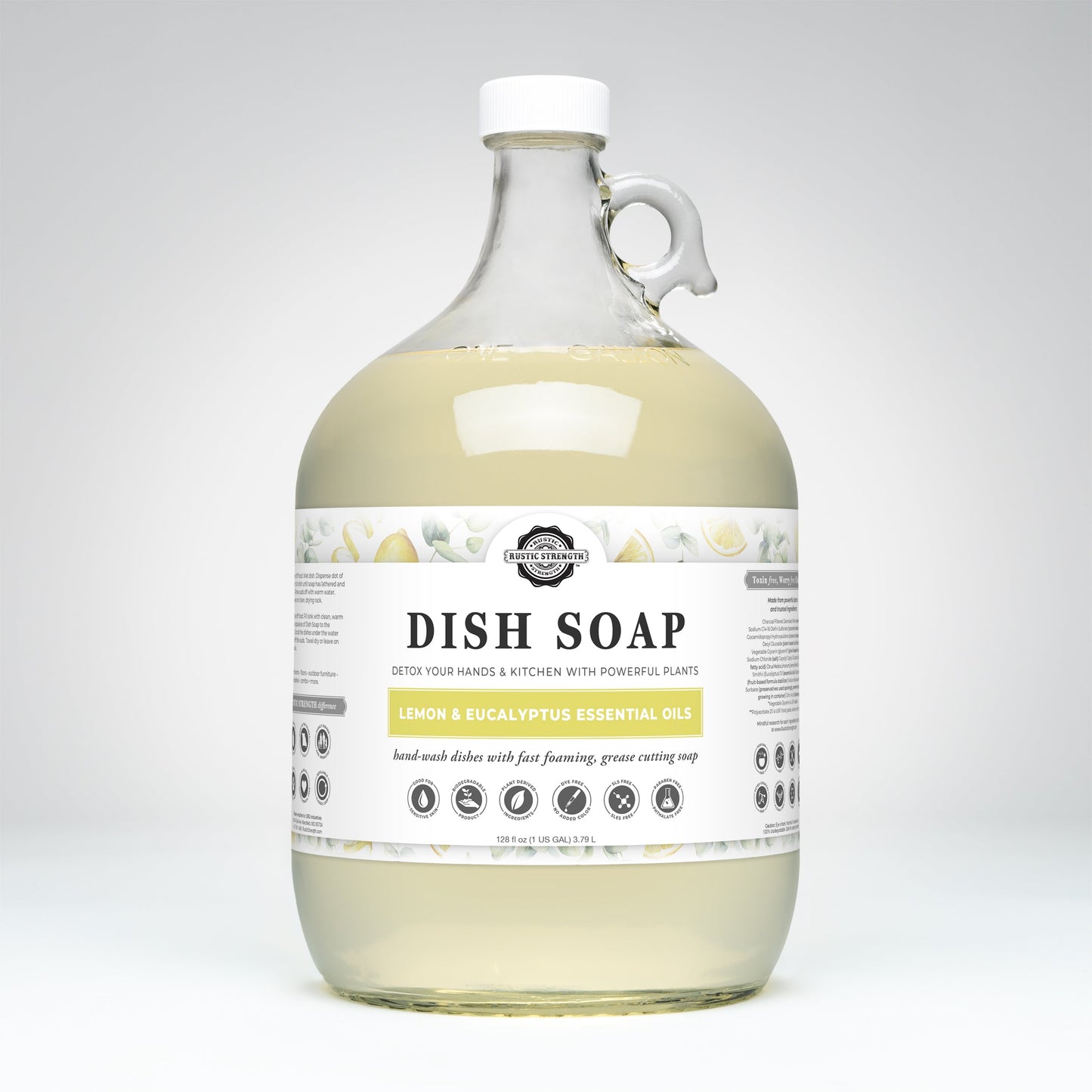 A clear, 1-gallon glass jug of Rustic Strength Dish Soap | Lemon & Eucalyptus, featuring a handle, white cap, and label listing lemon & eucalyptus essential oils. The background is plain light gray.