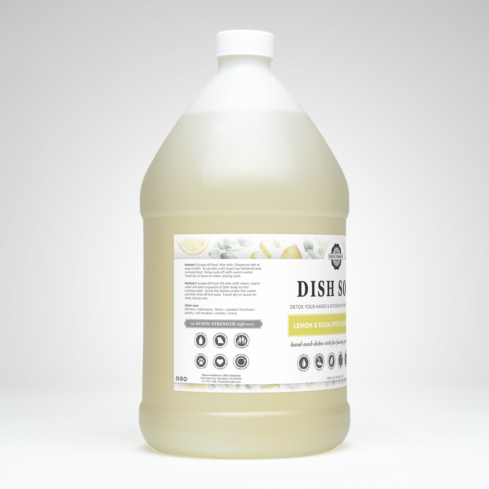 A large plastic jug of Rustic Strength Dish Soap | Lemon & Eucalyptus features a white cap, white label with lemon and eucalyptus leaf images, and is made with natural ingredients.