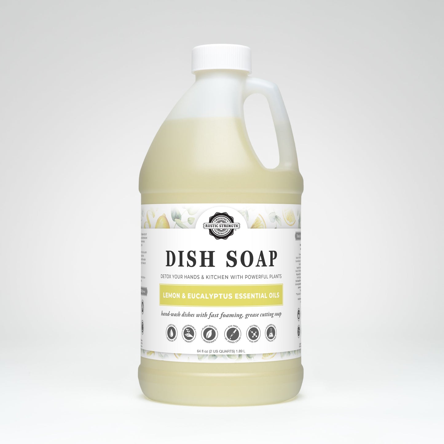 A large clear jug of Rustic Strength Dish Soap | Lemon & Eucalyptus with a white label, black text, and white cap sits on a plain light background. The soap is biodegradable and contains lemon and eucalyptus essential oils.