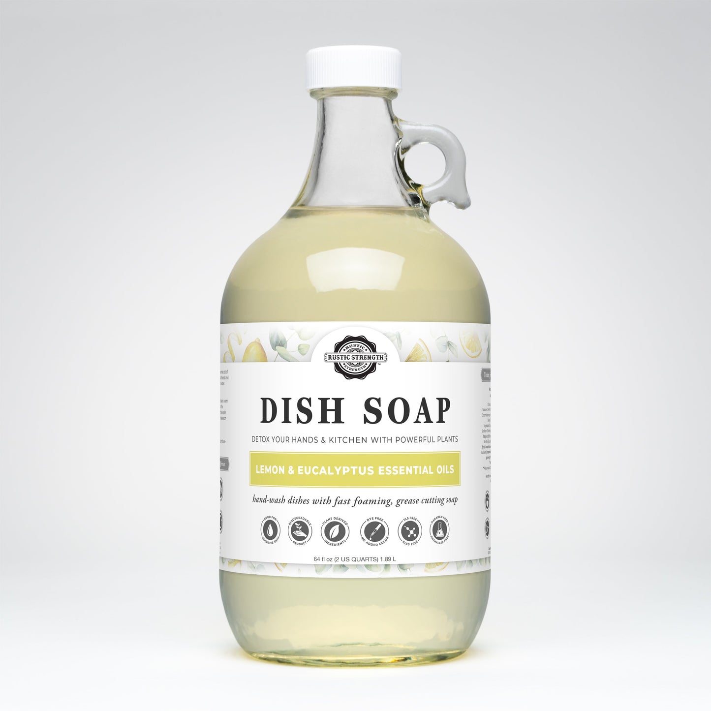 A clear, loop-handled bottle of Rustic Strength Dish Soap | Lemon & Eucalyptus contains light yellow, natural, biodegradable soap. The white label displays the product name and features small lemon and leaf illustrations.