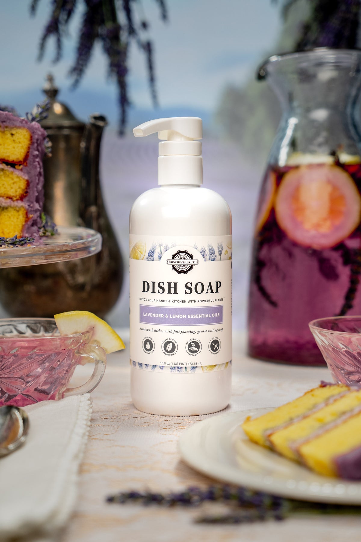 Rustic Strength lavender and lemon dish soap bottle with a pump dispenser on a kitchen countertop.