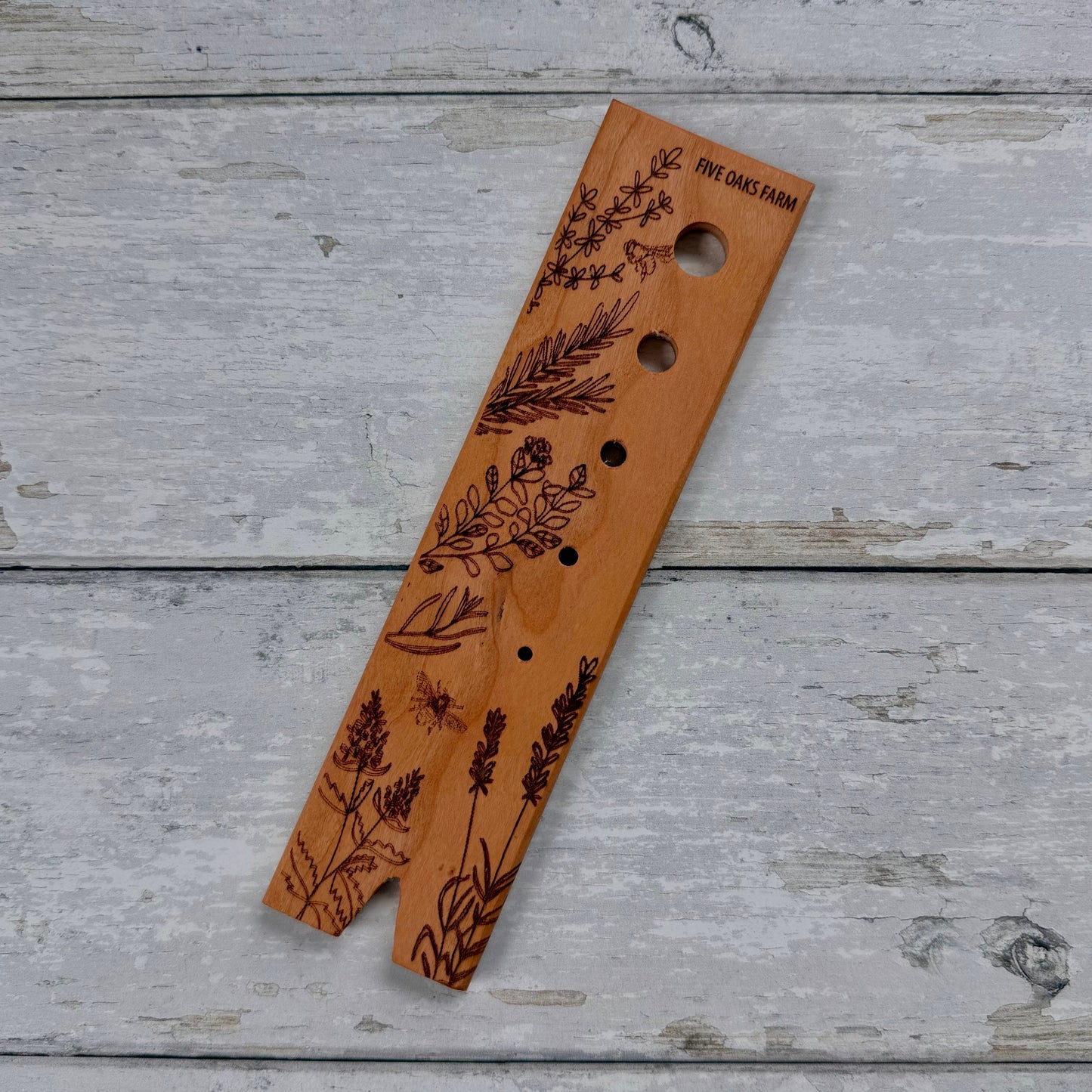 Five Oaks Farm herb stripper with multiple stainless steel holes for quickly removing leaves from herbs like basil and mint.