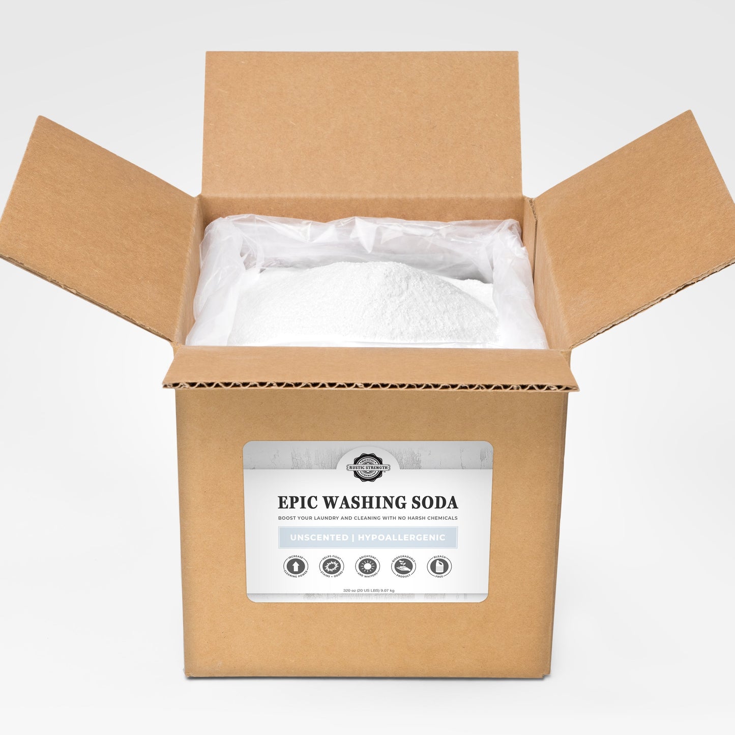 An open brown cardboard box reveals a large plastic-lined batch of Epic Washing Soda by Rustic Strength. The label highlights it as an unscented, hypoallergenic, powerful, and biodegradable laundry boost and cleaner.