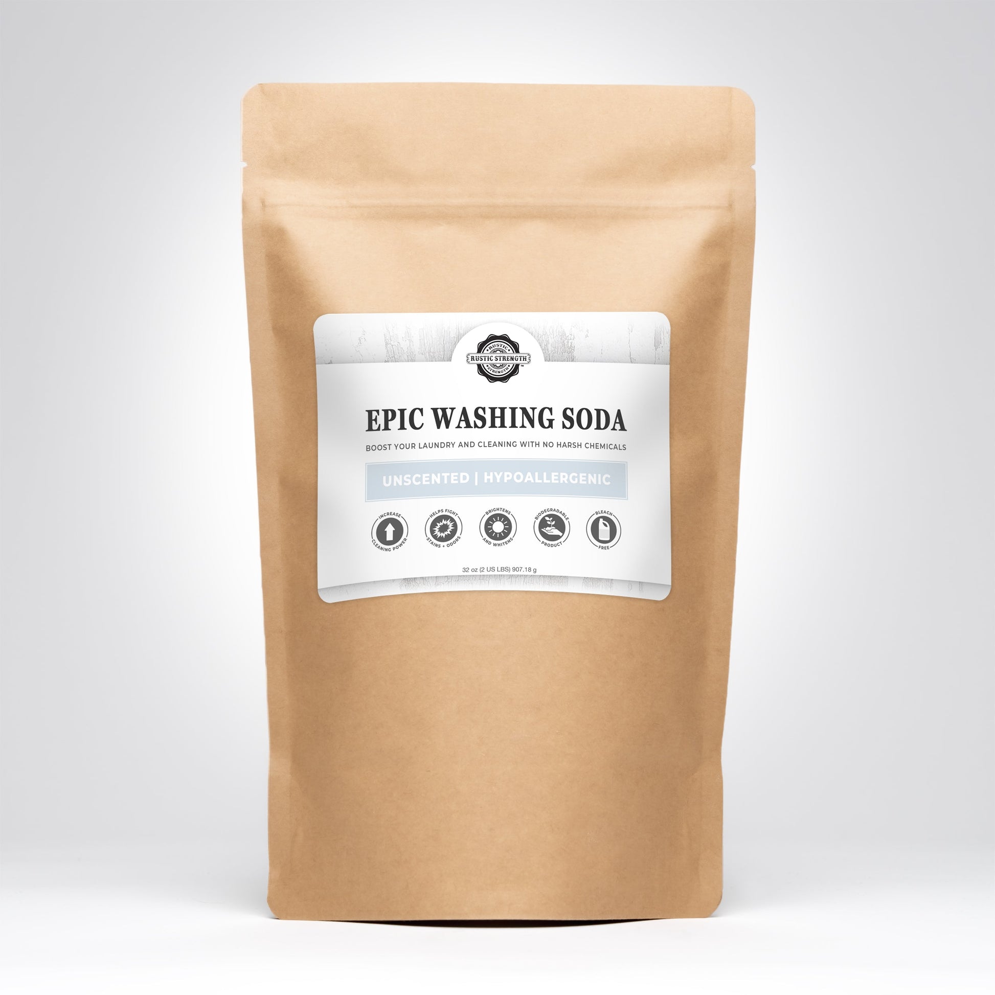 A brown paper bag labeled Epic Washing Soda by Rustic Strength, featuring text promoting its unscented, hypoallergenic Laundry Boost formula, stands upright against a plain light gray background.