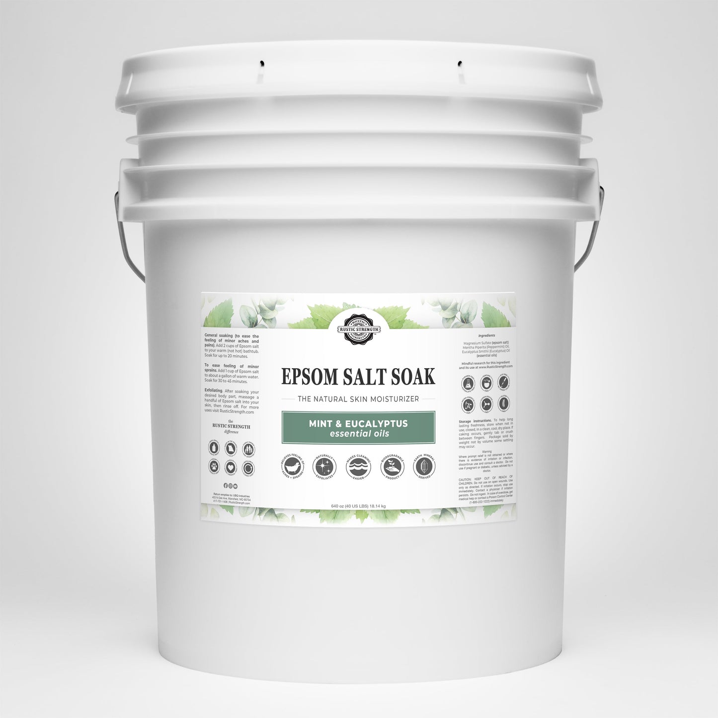 A large white plastic bucket of Rustic Strength Epsom Salt Soak | Mint & Eucalyptus, with green leaf accents and product info. Infused with pure essential oils, it features a sturdy metal handle.