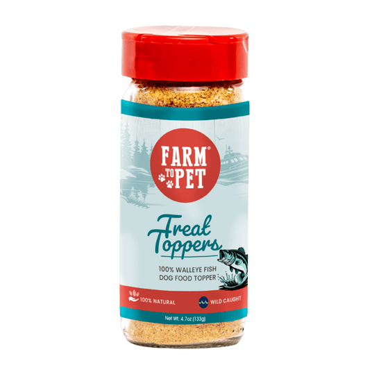 A bottle of Farm To Pet Treat Topper Fish Dog Food Topper with a red cap and label, featuring fish and nature illustrations, made from 100% human-grade walleye fillets rich in omega-3.