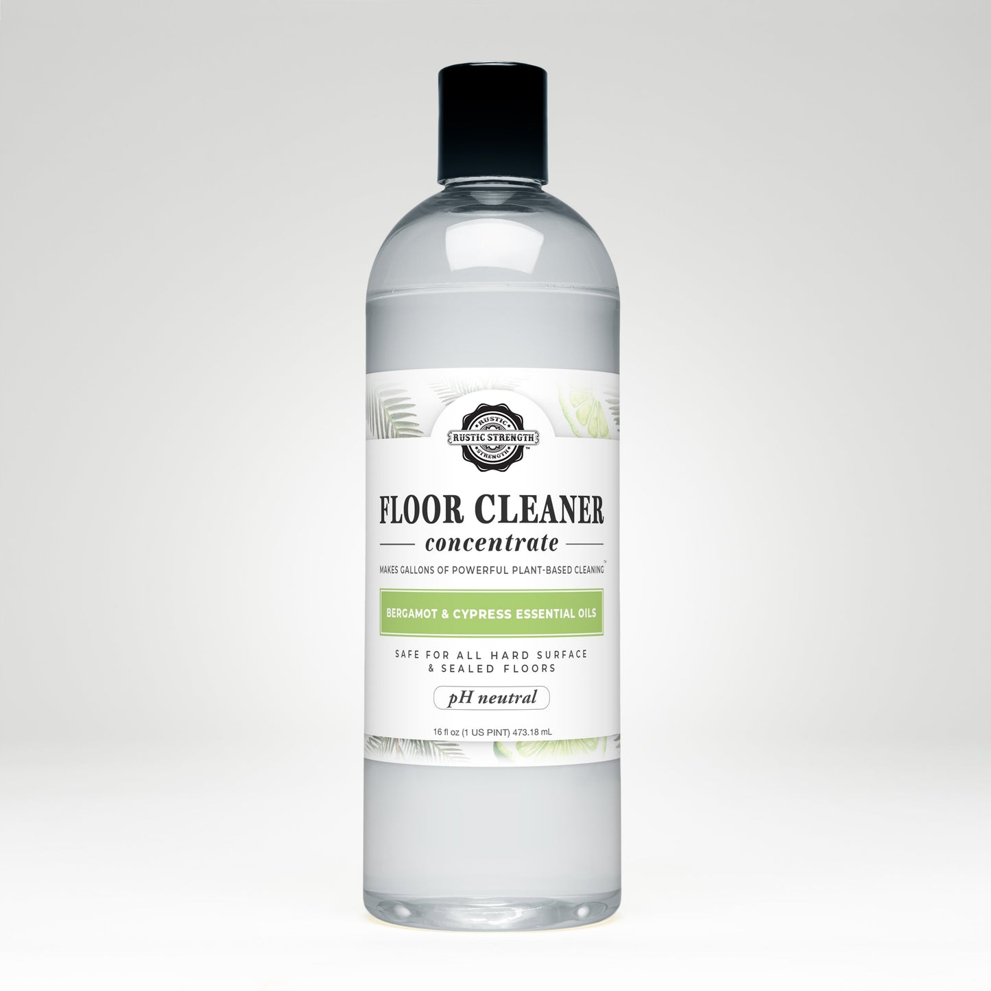 Rustic Strength Floor Cleaner Concentrate | Bergamot & Cypress comes in a clear plastic bottle with a black cap and white label with green leaves. Its plant-based, pH neutral, non-toxic, and infused with bergamot & cypress essential oils.