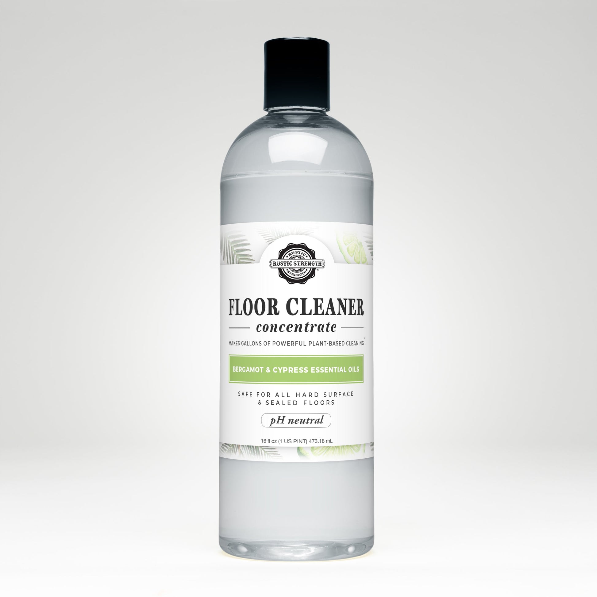 Rustic Strength Floor Cleaner Concentrate | Bergamot & Cypress comes in a clear plastic bottle with a black cap and white label with green leaves. Its plant-based, pH neutral, non-toxic, and infused with bergamot & cypress essential oils.