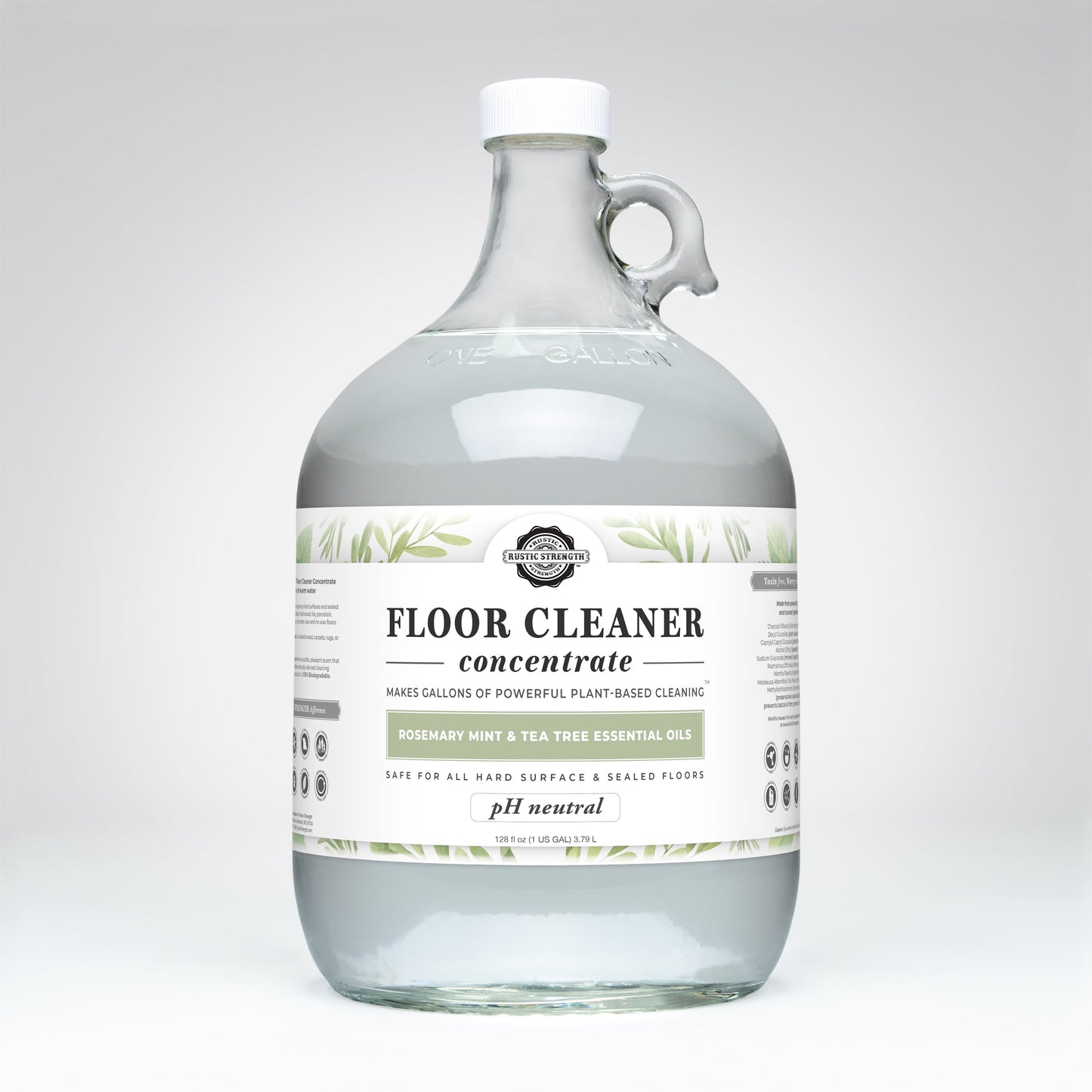 A clear one-gallon jug of Rustic Strength Floor Cleaner Concentrate | Rosemary, Mint & Tea Tree, pH neutral and non-toxic for hard surfaces. The white label has green leaf graphics and black text.