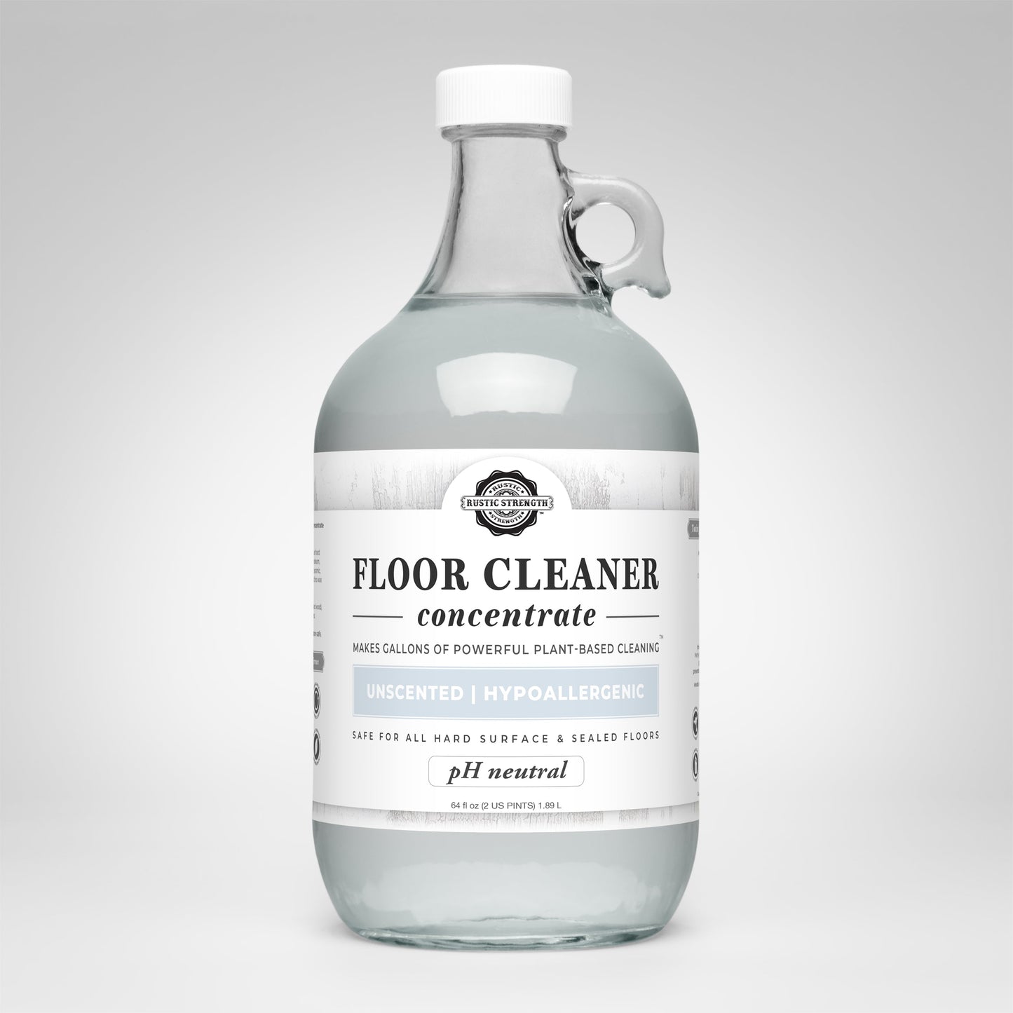 A clear glass bottle labeled Rustic Strength Floor Cleaner Concentrate | Unscented contains a non-toxic, plant-based cleaner that is hypoallergenic, pH neutral, and safe for hard surfaces and sealed floors.