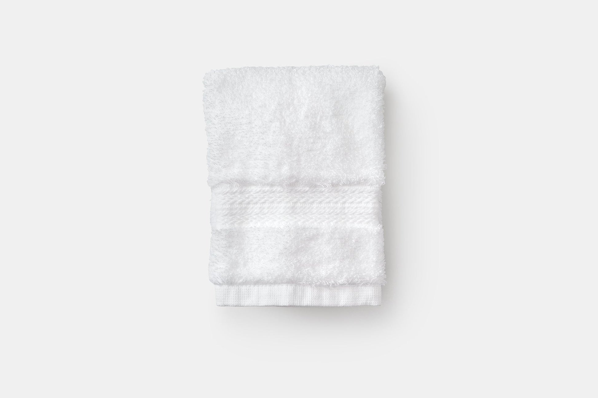 White luxury USA cotton bathroom washcloths from American Blossom Linens, folded, soft and natural for gentle bath use.