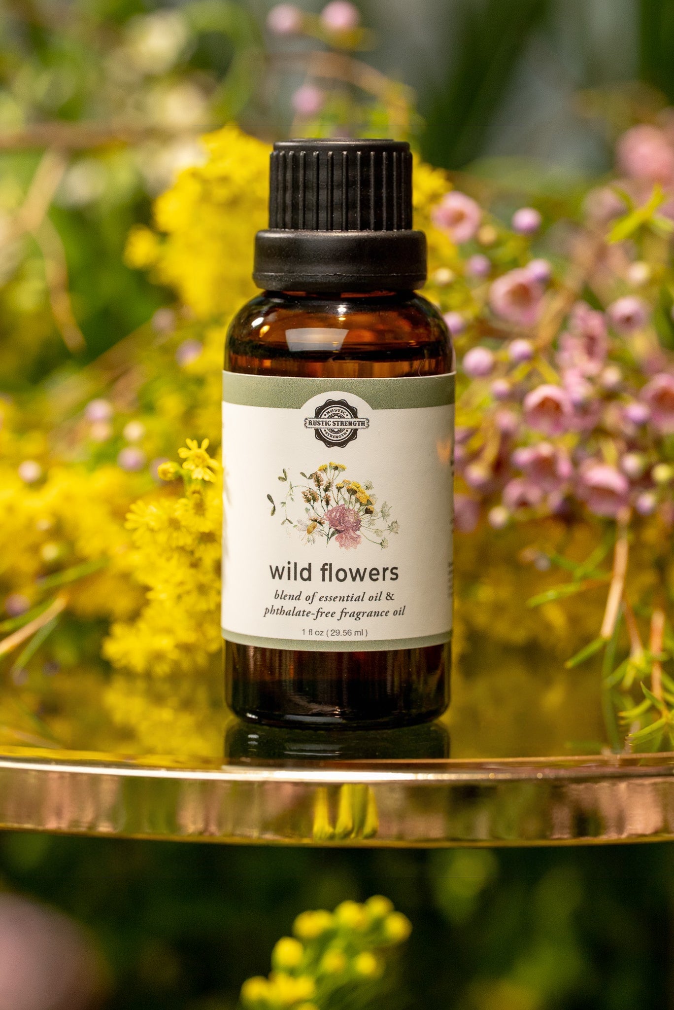 Rustic Strength Wild Flowers essential oil fragrance blend in a clear glass bottle, showcasing vibrant floral scent.