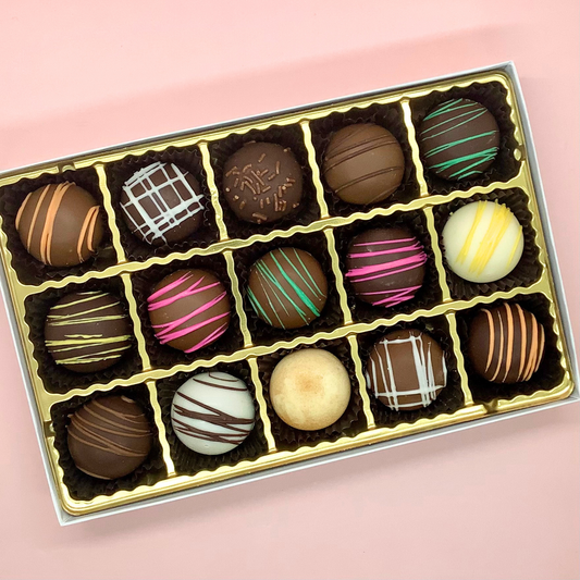 Assorted fudge truffles in a box from Fudge Co., featuring a variety of rich, creamy chocolate flavors in a medium-sized gift box.