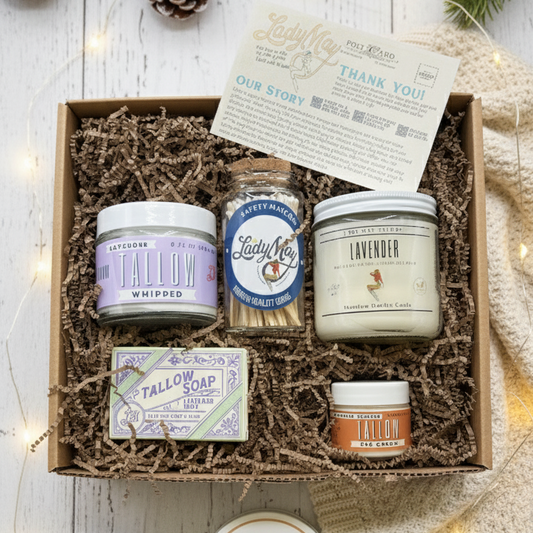 The Lady May Tallow Lavender "Relax" Premium Gift Box includes all natural tallow soap, a lavender tallow candle, whipped tallow moisturizer, Honey & Garlic Co. jar, Cug Crunch snack, info cards—all beautifully arranged for a cozy presentation.