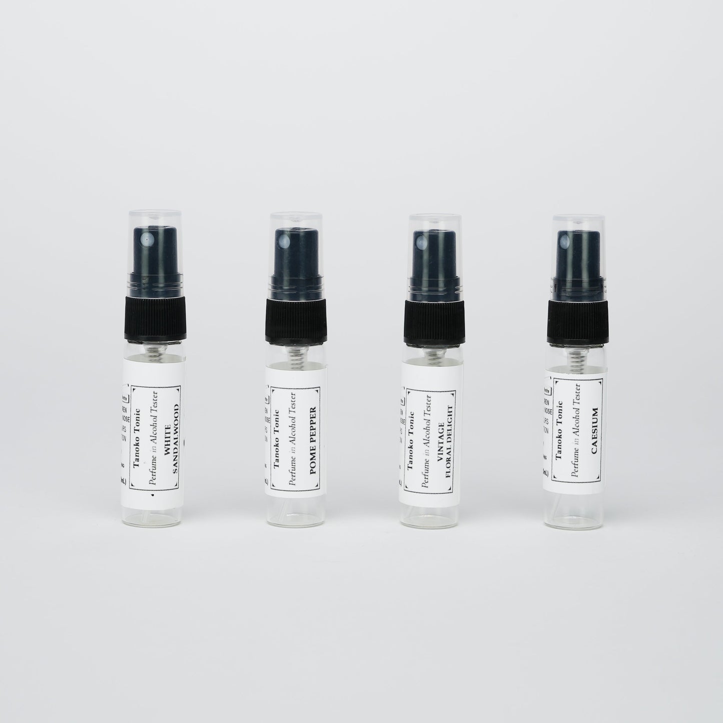 Rustic Strength’s Perfume Sample Pack | One Vial of Each Scent features four labeled vials lined up against a white background—ideal for creating your own refillable collection of unique fragrances.