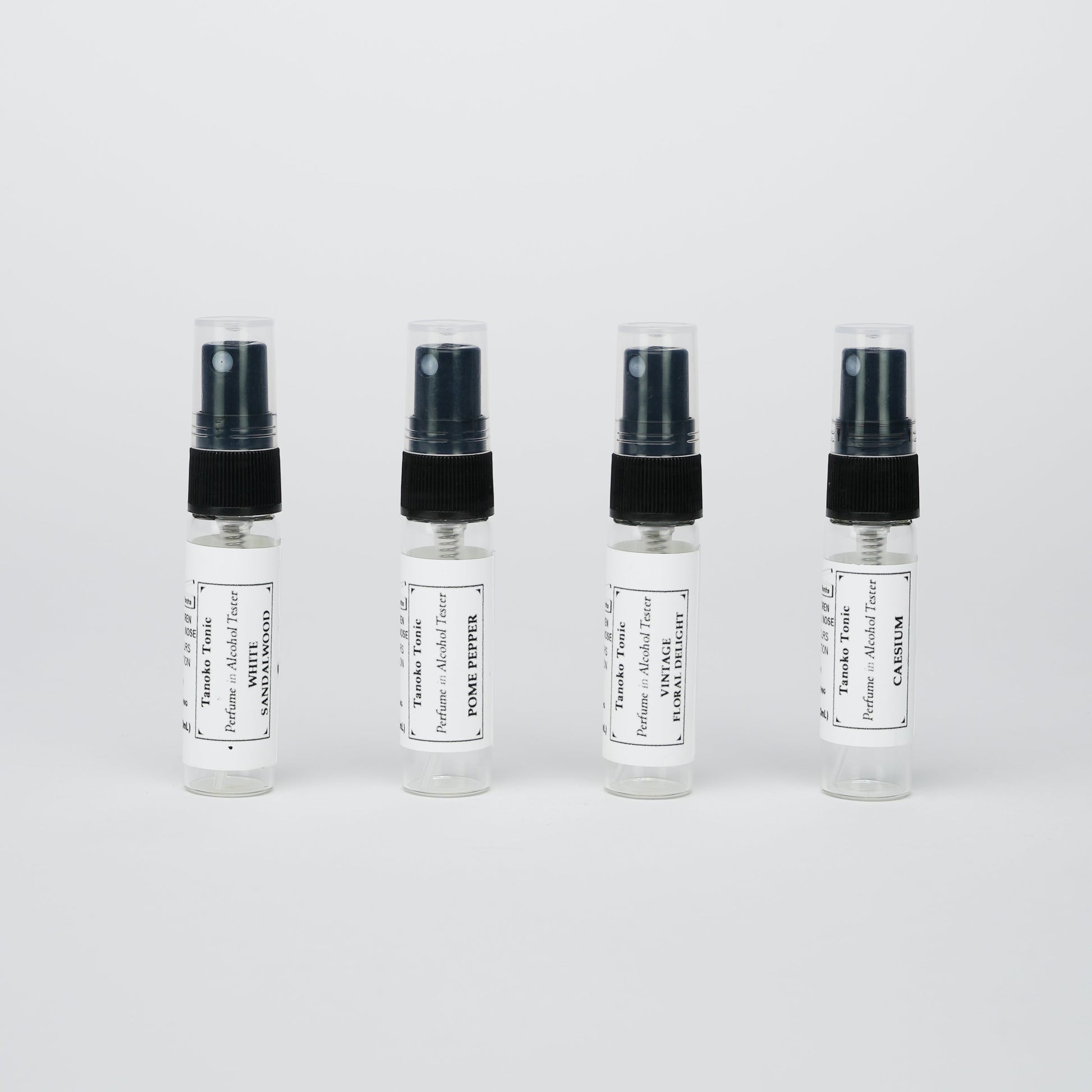 Rustic Strength’s Perfume Sample Pack | One Vial of Each Scent features four labeled vials lined up against a white background—ideal for creating your own refillable collection of unique fragrances.
